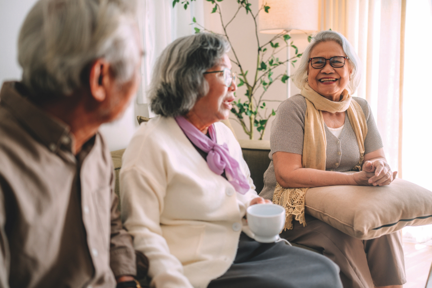 A group of older people sitting and talking.