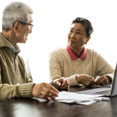A senior couple working together on a laptop