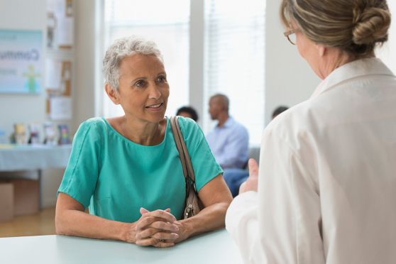 Woman talking to doctor.